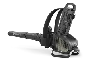 Side view of a Husqvarna leaf blower with open battery compartment.