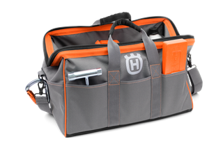Front view of a Husqvarna tool bag with multiple compartments and a visible tool.