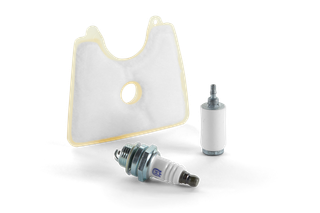 Top view of a spark plug, fuel filter, and air filter for garden machinery.