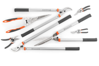 Top view of various Husqvarna gardening tools including shears, pruners, and loppers.