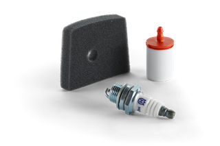 Top view of a spark plug, foam filter, and fuel filter, showcasing engine maintenance components.