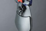 Close-up of a protective shield with an adjustable strap and buckle.