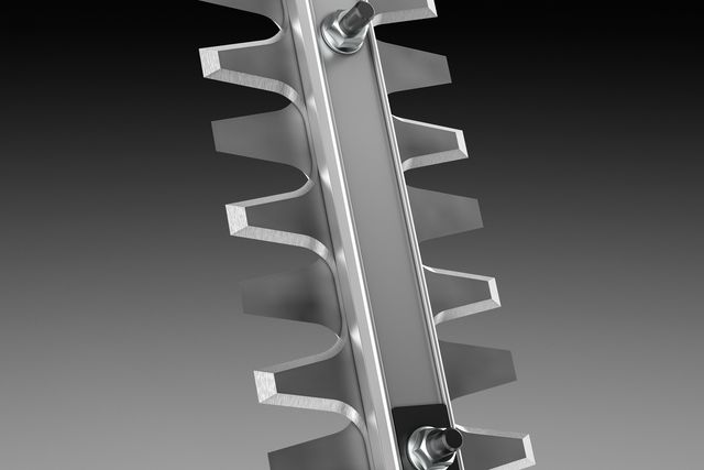 Close-up view of a metal blade with sharp teeth, possibly for cutting or trimming.