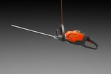 Side view of a hedge trimmer suspended by a cord.