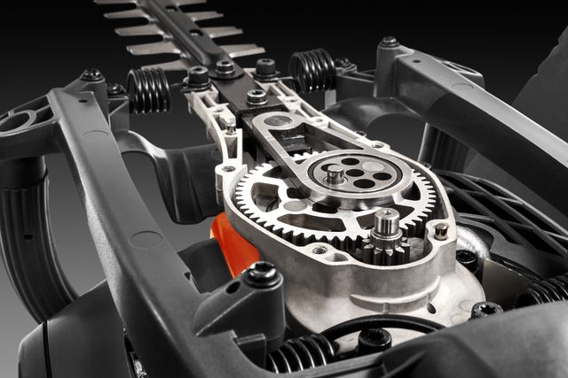 Close-up view of a hedge trimmer's internal mechanism, showcasing gears and components.