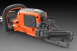 Side view of a chainsaw with ergonomic handle and control panel.