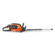 Widok z boku nożyc do żywopłotu Husqvarna z widoczną komorą akumulatora.