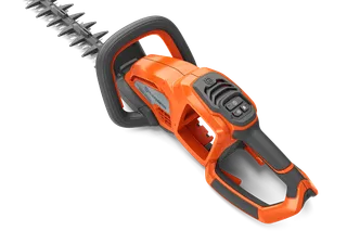 Side view of a Husqvarna hedge trimmer with ergonomic handle and control panel.