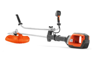 Side view of a Husqvarna brush cutter with ergonomic handle and cutting blade.
