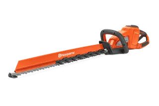 Side view of a Husqvarna hedge trimmer with a long cutting blade.