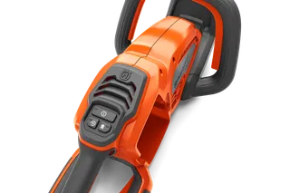 Close-up view of a Husqvarna product handle with control buttons.