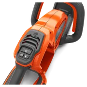Close-up view of a Husqvarna product handle with control buttons.