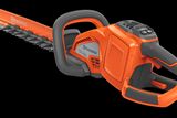 Side view of a Husqvarna hedge trimmer showcasing its ergonomic handle and blade.