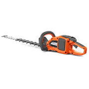 Side view of a Husqvarna hedge trimmer with ergonomic handle.