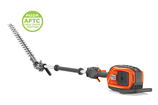 Side view of a Husqvarna battery pole hedge trimmer with telescopic shaft, AGZA AFTC badge.