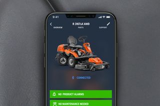 Smartphone displaying a lawn mower app interface with usage statistics and status indicators.