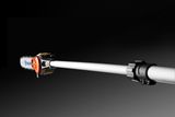 Side view of a Husqvarna pole saw with an extended reach, showcasing the cutting blade.