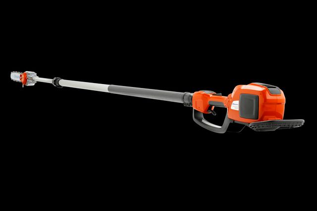 Side view of a Husqvarna battery-powered pole saw, showcasing its extended reach.
