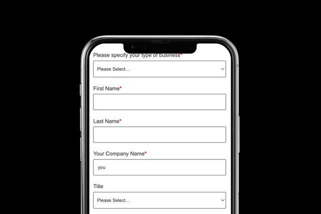Mobile phone displaying a business registration form with fields for type of business, first name, last name, company name, and title.