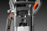 Close-up view of a pressure washer with hose reel and handle.