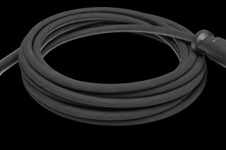 Coiled black audio cable with a male and female connector.