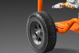 Close-up of a construction equipment wheel and engine components.