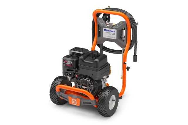 Petrol Pressure Washer. Side view of a Husqvarna pressure washer with sturdy wheels and hose attachment.
