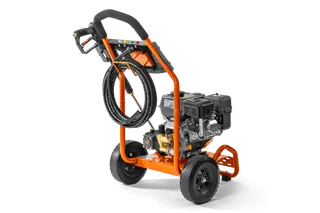 Side view of a construction pressure washer with hose and ergonomic handle.