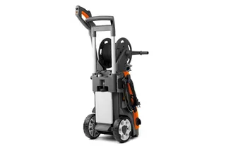 Rear view of a pressure washer with hose reel and large wheels.