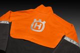 Rear view of a work jacket with a prominent logo on the back.