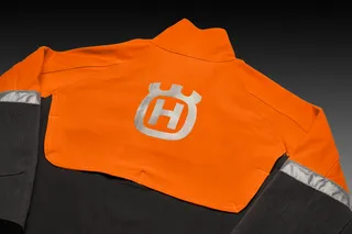 Rear view of a work jacket with a prominent logo on the back.