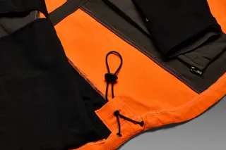Close-up view of the interior of a work jacket showing the drawstring and stitching details.
