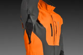 Side view of a work jacket with a raised arm, showcasing ventilation zippers.