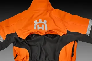 Rear view of a Husqvarna work jacket with ventilation features.
