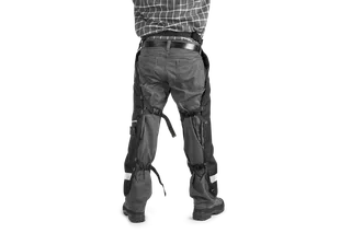 Functional Apron Chainsaw Chaps. Person facing away wearing Husqvarna chainsaw trousers.