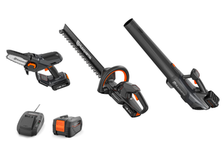 Studio image of Husqvarna gardening tools including a chainsaw, hedge trimmer, leaf blower, battery, and charger.