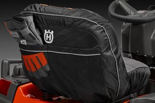 Close-up of a Husqvarna ride-on mower seat with protective cover.