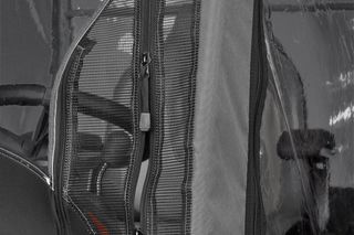Close-up view of a Husqvarna product with protective covering and zippers.
