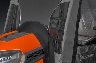 Close-up of a Husqvarna ride-on mower with protective canopy.