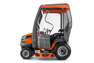 Side view of a Husqvarna ride-on mower with protective cab.