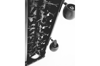 Close-up view of a mower's cutting blades and wheels.