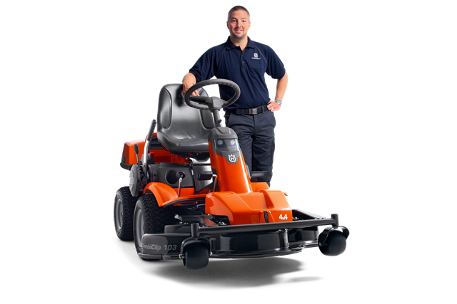 A person standing beside a Husqvarna ride-on mower, showcasing its design and features.