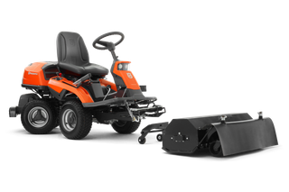 Side view of a Husqvarna ride-on mower with an attached accessory.