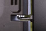Close-up view of a mechanical component with a bolt and a textured surface.