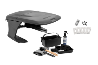 Husqvarna robotic mower shelter with maintenance kit including blades, cleaner, brush and tray.