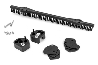Top view of a brush and various small mechanical parts, including screws and plates.