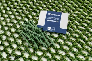 Husqvarna Automower hybrid grass mat with stakes and packaging.