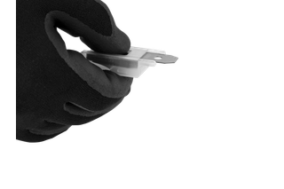 Close-up studio shot of a hand holding a small metal blade with a mounting hole.