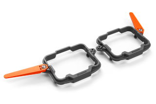 Top view of a Husqvarna accessory with two rectangular frames and orange levers.