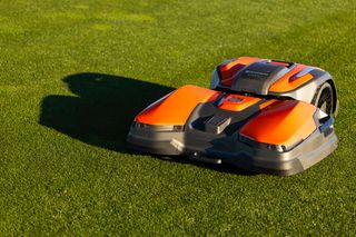 Robotic lawn mower operating on a well-maintained lawn.